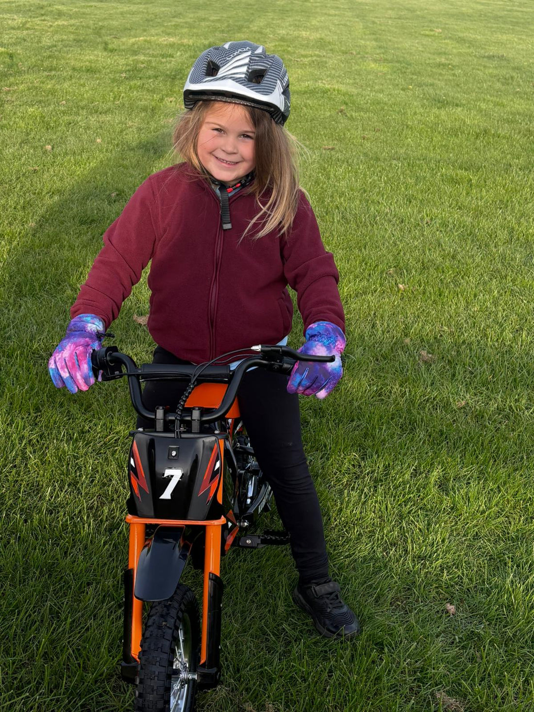 Boy aged 6-12 riding a Kubbi electric dirt bike as a birthday gift