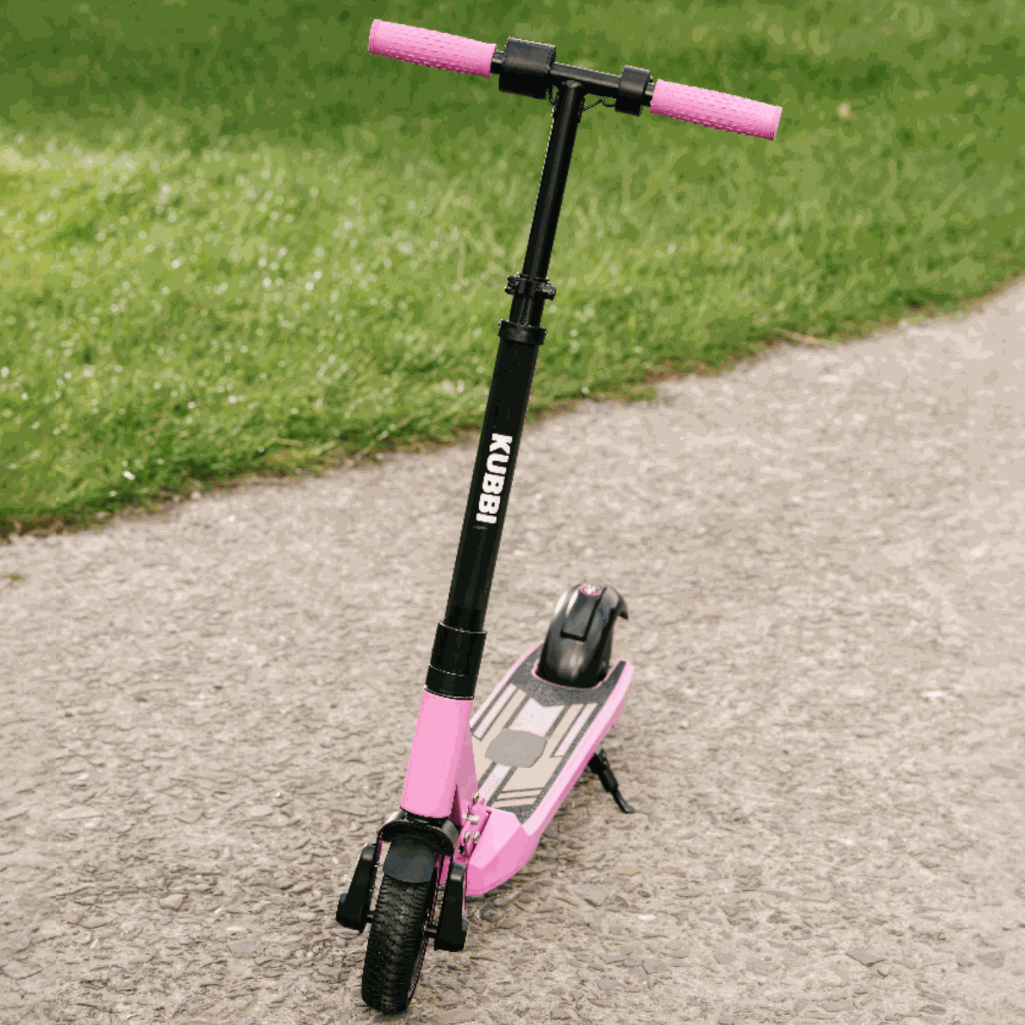 Kubbi S9 Pro kids electric scooter with pink handlebars and deck, designed for ages 4-12, on pavement path outdoors