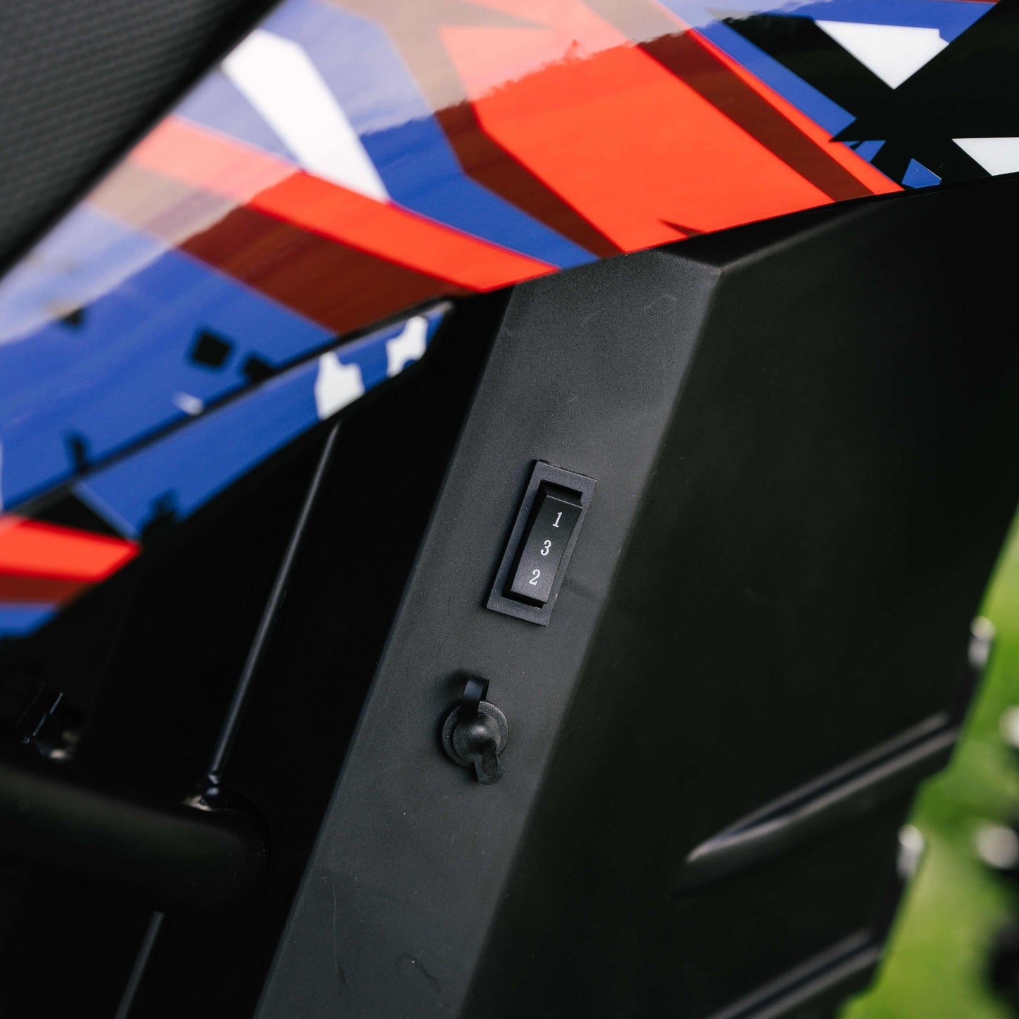 Close-up of Kubbi K10 Pro electric dirt bike speed gear switch and colorful body panel