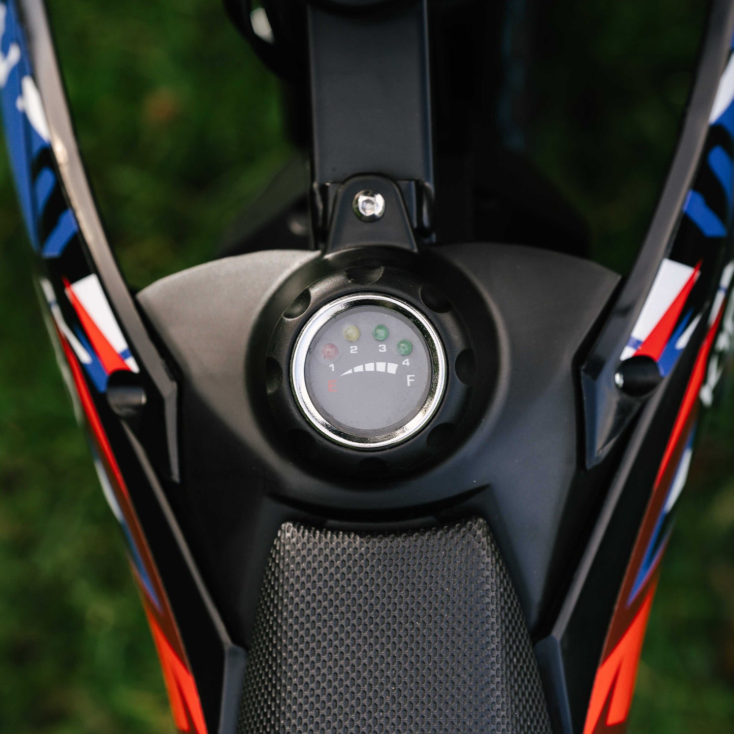 Close-up of Kubbi K10 Pro kids electric dirt bike fuel gauge and handlebar controls